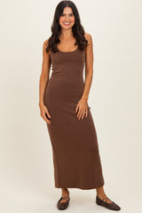woman wearing a fitted brown maxi dress with a scoop neckline and a straight silhouette
