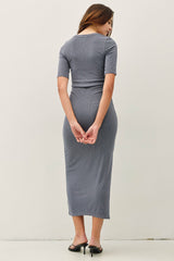 woman wearing a fitted gray ribbed midi dress with short sleeves, view from the back