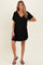 woman wearing a black short sleeve maternity dress with a v-neckline and a flowy silhouette, showcasing her baby bump