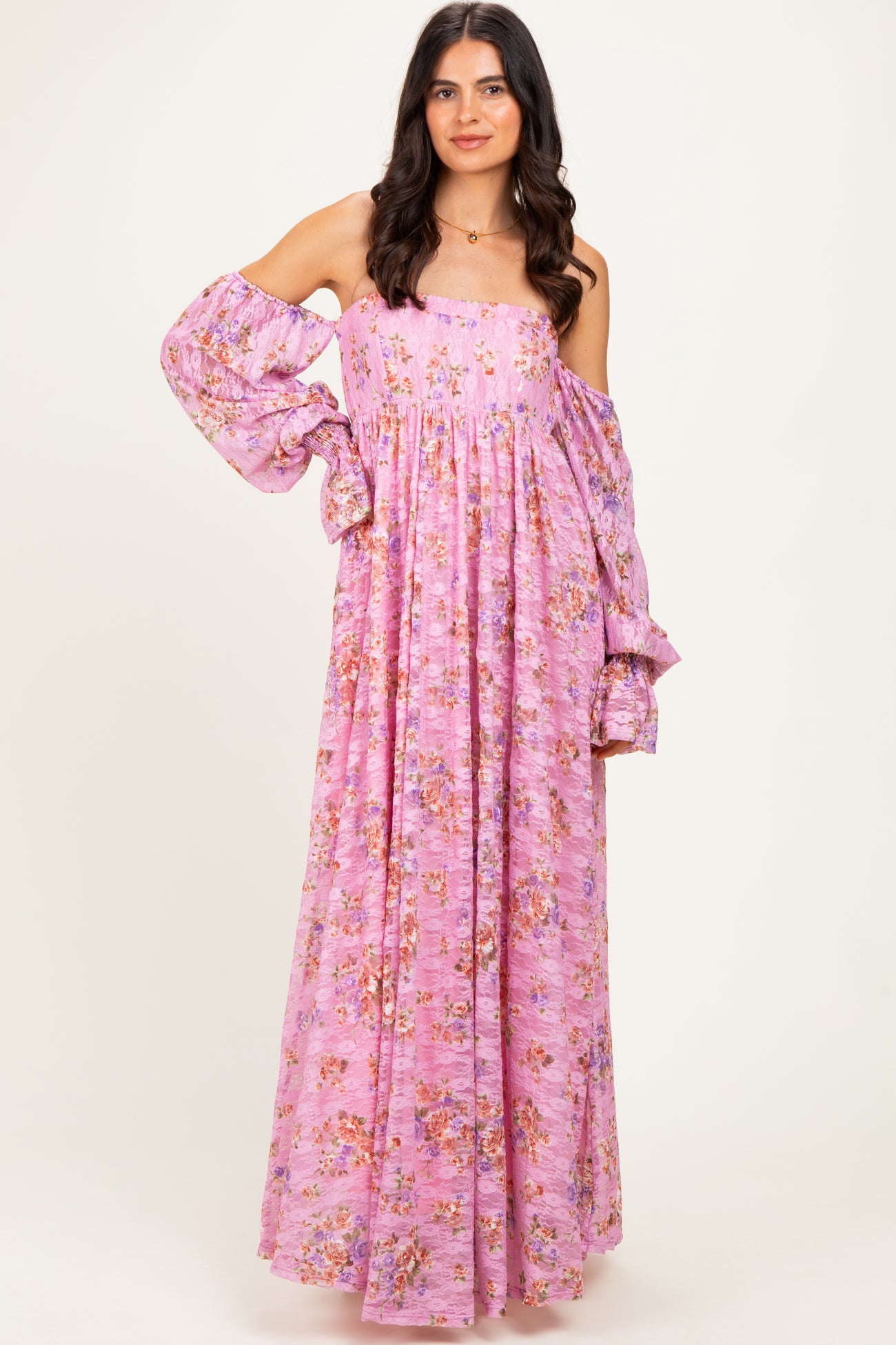 woman wearing a lavender off-shoulder maxi dress with floral print and bell sleeves