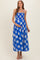 woman wearing a blue floral maternity dress with a flowy fit and a visible baby bump