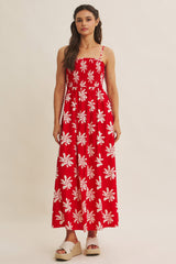 woman wearing a red floral print maxi dress with a square neckline and spaghetti straps