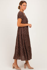 woman wearing a brown polka dot maxi dress with short sleeves and a tiered skirt, styled with nude heels