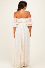 woman wearing a white lace off-the-shoulder maternity maxi dress, showing a relaxed fit and ruffled sleeves from the back