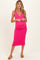 woman wearing a bright pink ribbed maternity dress with a deep v-neck and a visible baby bump