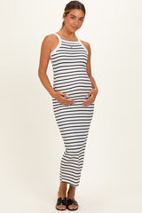 woman wearing a striped maternity midi dress and cradling her baby bump