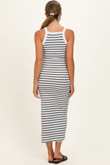 woman wearing a black and white striped maternity maxi dress, viewed from the back