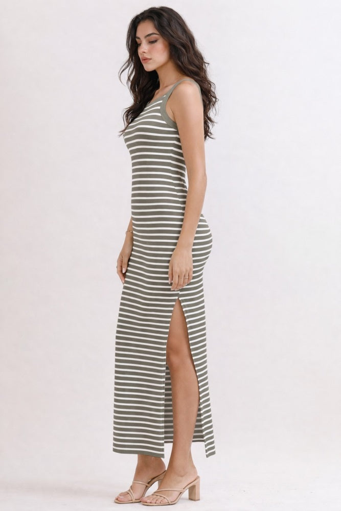 woman wearing a green and white striped maxi dress with a side slit and spaghetti straps