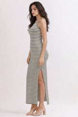 woman wearing a green and white striped maxi dress with a side slit and spaghetti straps