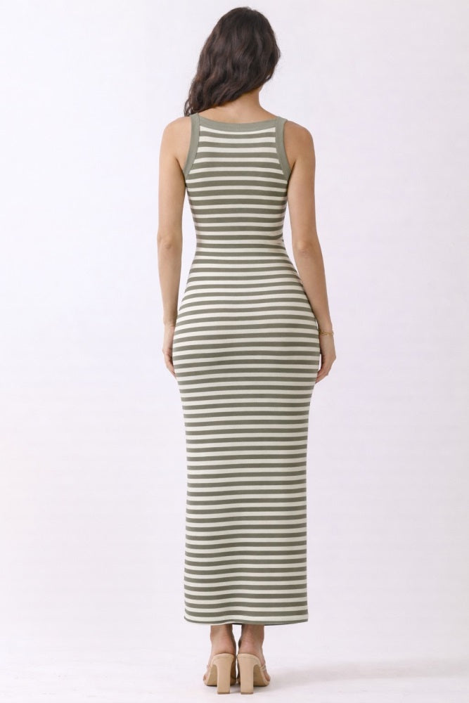 woman wearing a green and white striped maxi dress with a fitted silhouette, view from the back