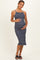 woman wearing a navy striped maternity dress and holding her baby bump