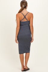 woman wearing a navy blue striped maternity dress with a crisscross back design