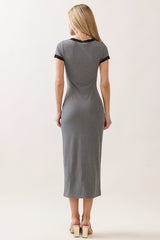 woman wearing a gray maxi dress with short black sleeves, standing with her back to the camera