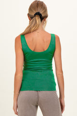 woman wearing a green maternity tank top, shown from the back