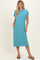 woman wearing a teal short sleeve midi dress with a pocket and side pockets, standing with a relaxed pose