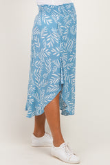 woman wearing a light blue maternity skirt with a leaf print and an asymmetrical hem