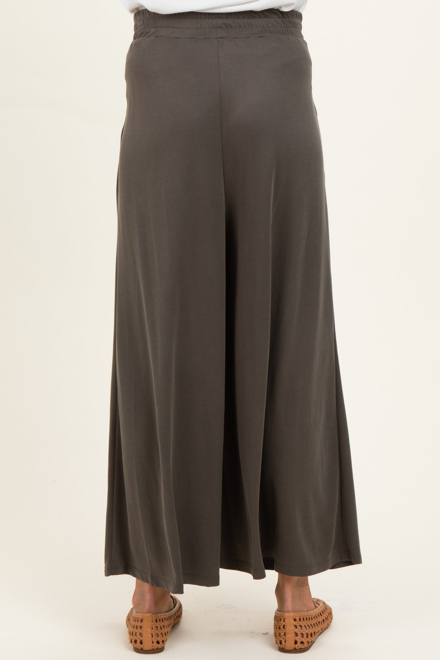 maternity wear long dark gray wide-leg pants showing the back view with an elastic waistband