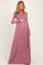 woman wearing a mauve off-the-shoulder maxi maternity dress and holding her baby bump