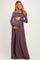 woman wearing a mauve off-the-shoulder maternity gown and holding her baby bump