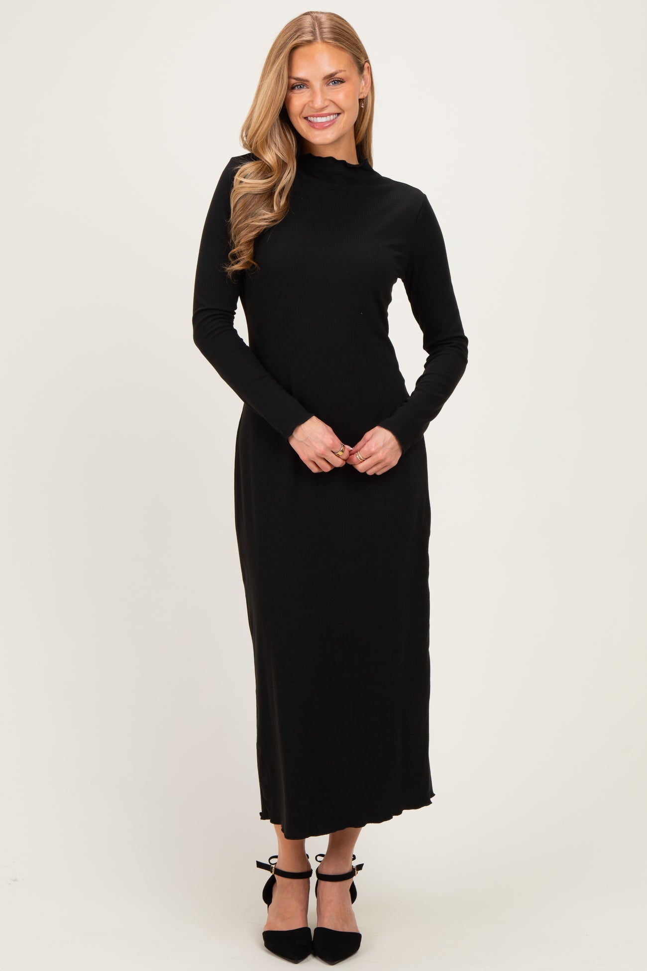 woman wearing a black long sleeve ribbed maxi dress with a high neckline