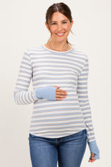 woman wearing a striped maternity top with long sleeves and a baby bump