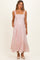 woman wearing a light pink floral maternity maxi dress with a smocked bodice and adjustable straps