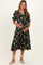 woman wearing a black floral maternity dress with ruffle details and a visible baby bump