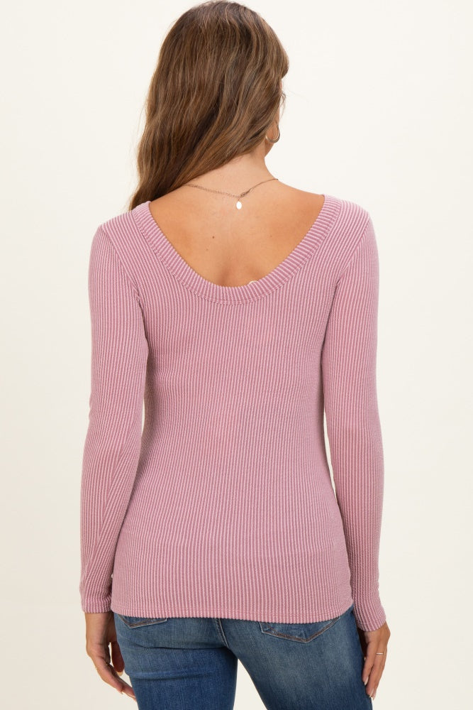 woman wearing a light pink long sleeve ribbed maternity top seen from the back