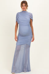 woman wearing a light blue maternity gown with ruching and a fitted silhouette, showcasing her baby bump
