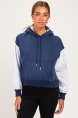 woman wearing a navy and gray color block maternity hoodie with a front pocket and hood