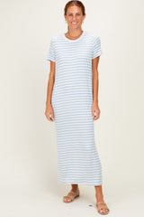 woman wearing a light blue striped maxi dress with short sleeves and standing in a neutral background