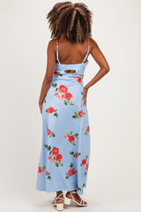 woman wearing a light blue floral maternity maxi dress with a back cutout and adjustable straps