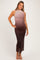 woman wearing a maternity wear ombre maxi dress in shades of pink to brown, highlighting her baby bump