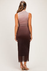 woman wearing a sleeveless ombre maternity dress, transitioning from light pink to dark brown, showing a fitted silhouette