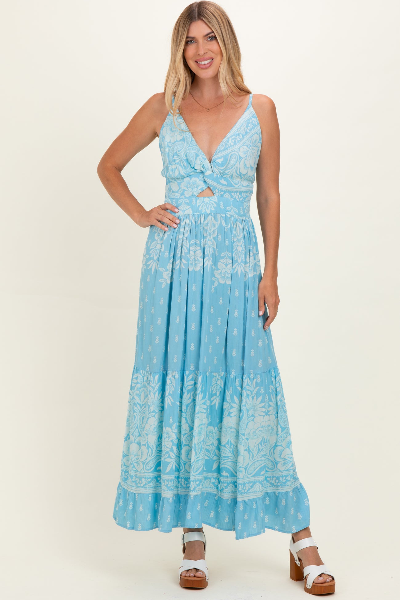 woman wearing a light blue floral maxi dress with a deep v-neck and tie-front detail