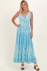 woman wearing a light blue floral maxi dress with a deep v-neck and tie-front detail