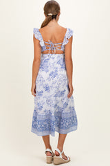 woman wearing a blue floral maternity dress with ruffle straps and a lace-up back detail