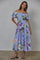 woman wearing a blue floral off-the-shoulder maxi dress with puff sleeves and pockets