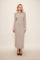 woman wearing a beige ribbed long sleeve maxi dress with button details and high heels