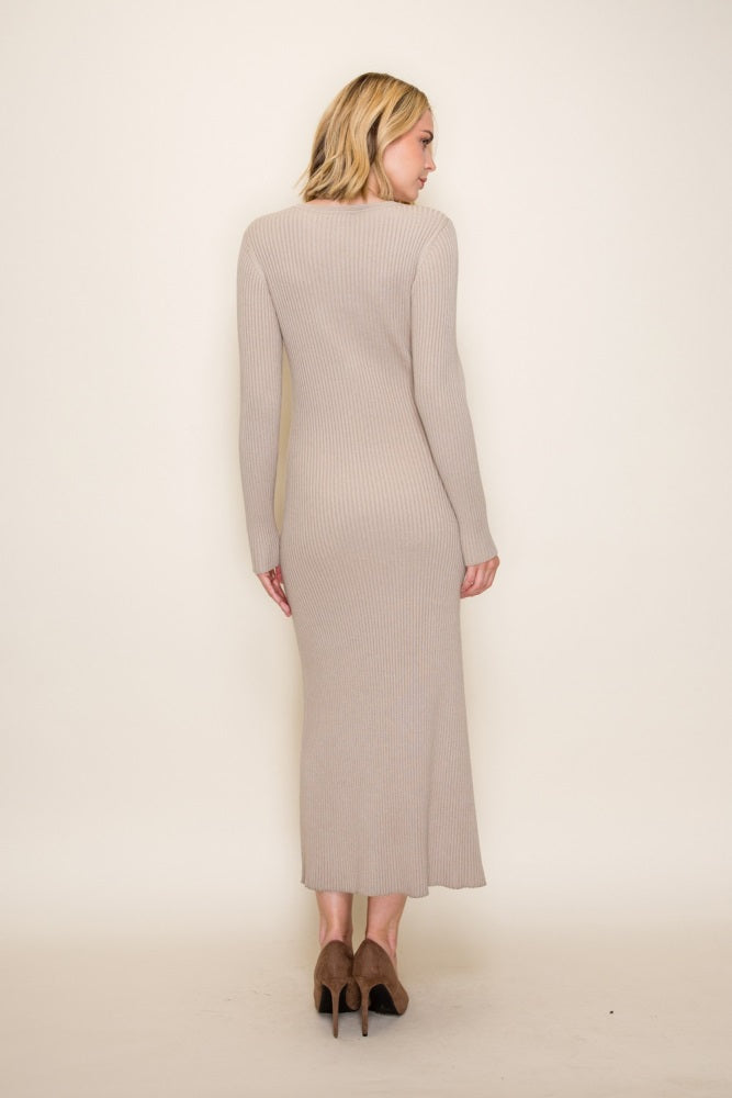 woman wearing a light beige ribbed long sleeve knit dress standing backwards with a fitted silhouette and midi length