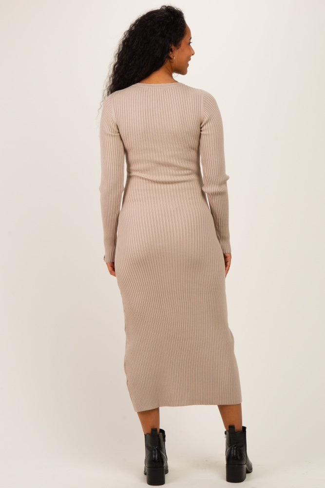woman wearing a ribbed beige maternity dress with long sleeves and a fitted silhouette, showing a baby bump from the back