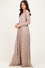 woman wearing a long sleeve beige lace maxi dress standing sideways with a relaxed fit