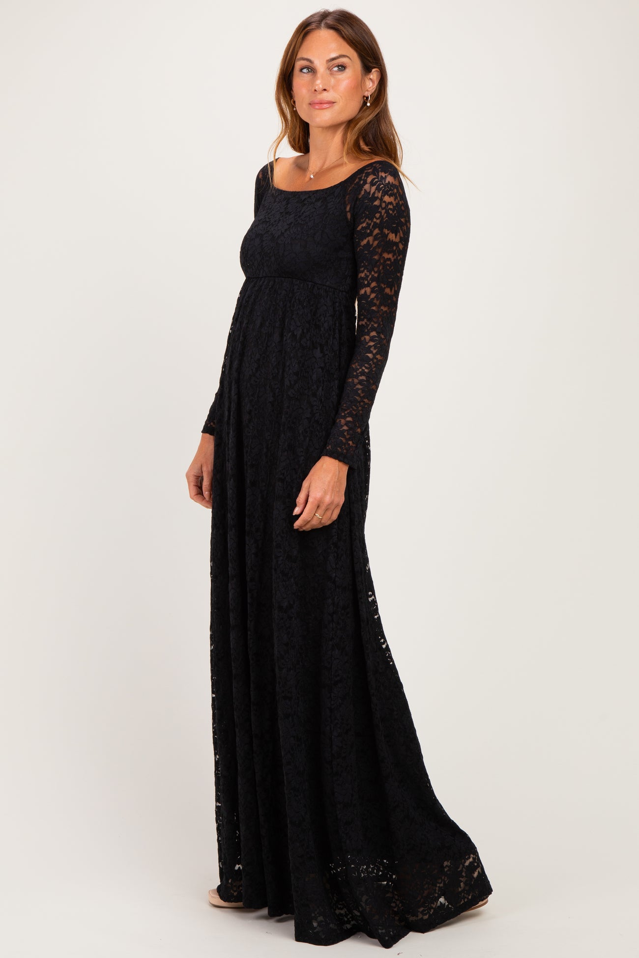 woman wearing a long black lace dress with long sleeves and a fitted bodice