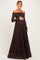 woman wearing a dark brown off-the-shoulder lace maternity gown and holding her baby bump