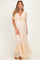 woman wearing a light peach lace maternity maxi dress with a tie front and flutter sleeves, showcasing her baby bump