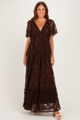 woman wearing a brown lace maxi dress with short sleeves and a deep v-neckline