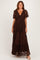woman wearing a brown lace maxi dress with short sleeves and a deep v-neckline