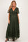 woman wearing a dark green lace maternity maxi dress with a tie detail and flutter sleeves, showing her baby bump