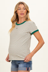 woman wearing a striped maternity t-shirt with green ribbed neckline and short sleeves, showing her baby bump