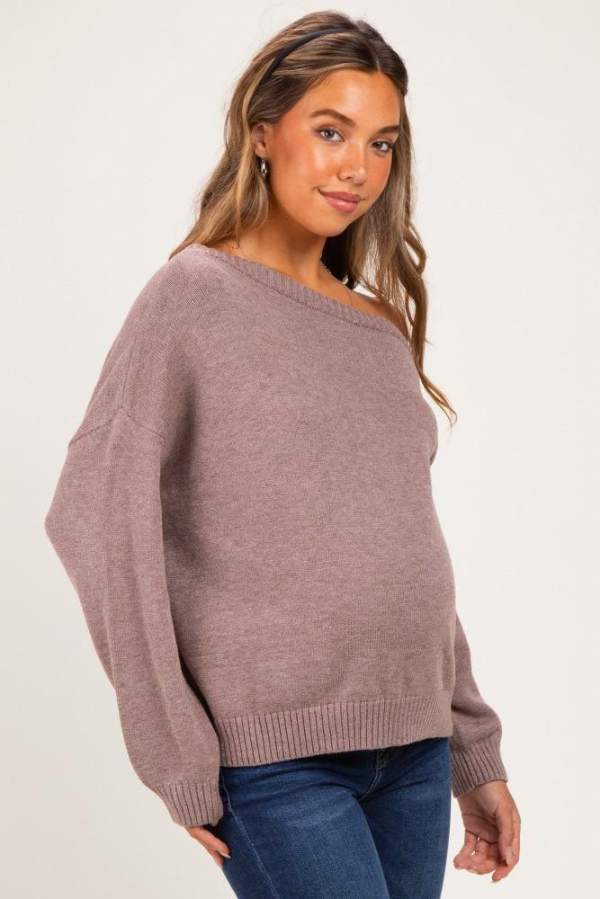 woman wearing a mauve maternity sweater with an off-the-shoulder neckline and a visible baby bump